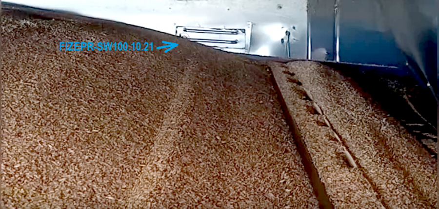 The FIZEPR‑SW100.10.21 sensor is mounted on the wall of a belt grain dryer.